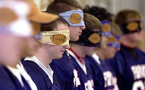Chenango Forks Senior Scott Lance is blindfolded along with other seniors on the football team during the pep rally Friday at the high school. They were led to believe the cheerleaders were going to kiss them, but instead it was their mothers. 